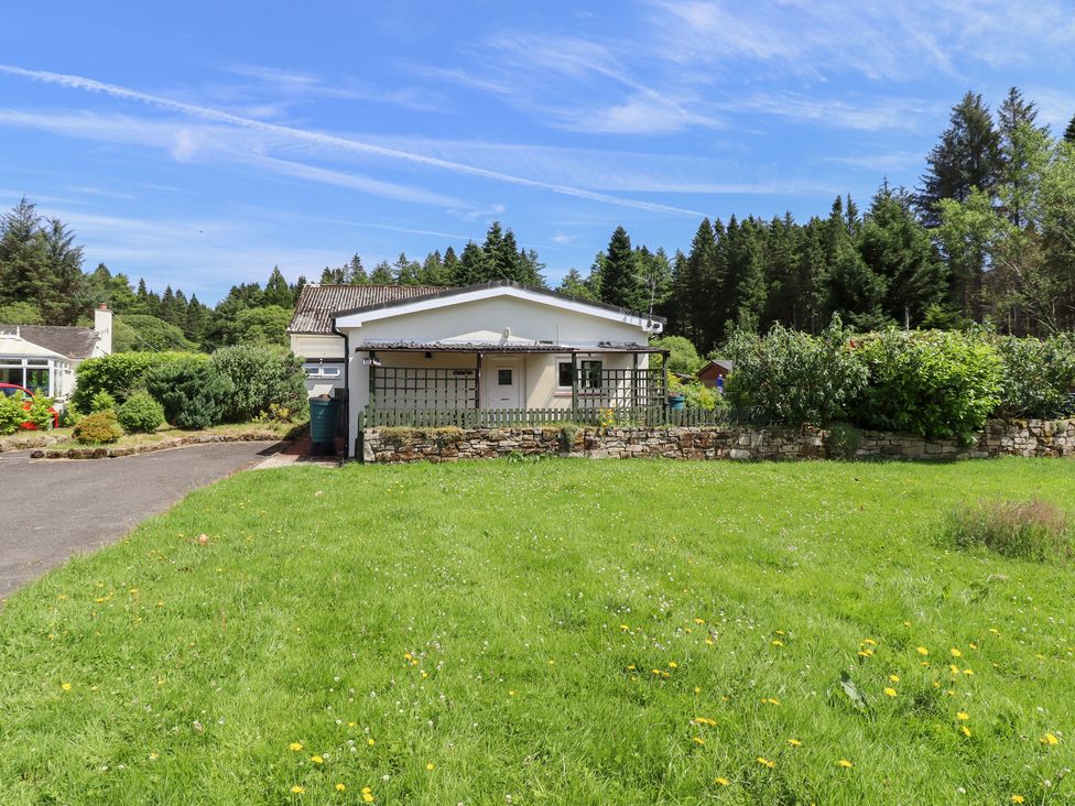 A house with a garden and driveway at Fir Tree Cottage near Cottonshopeburnfoot
