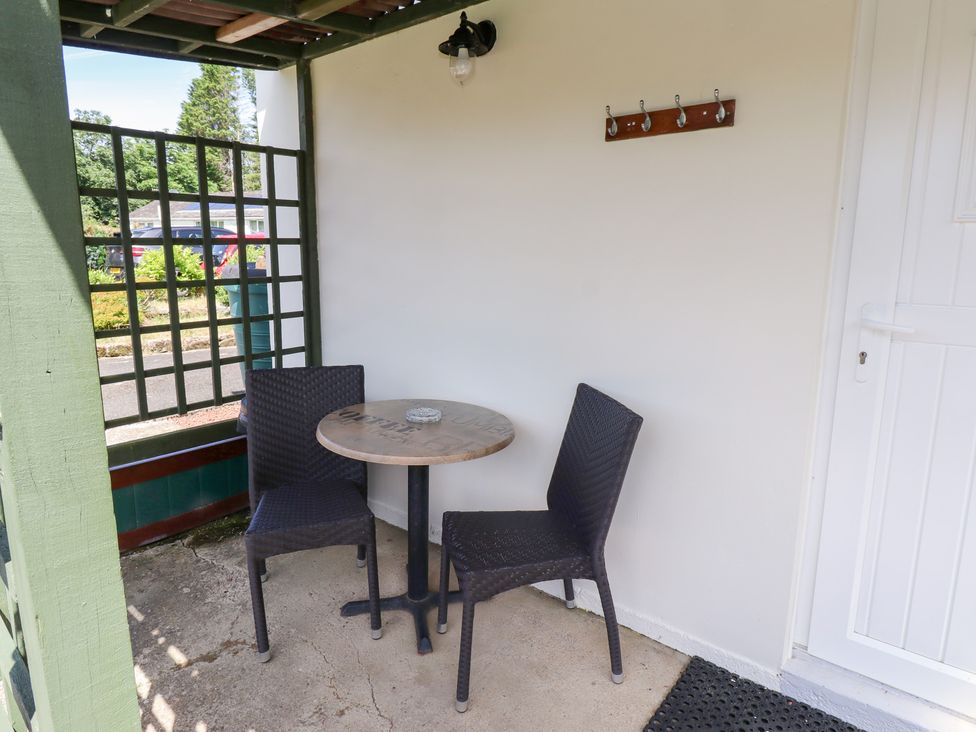 An outdoor seating area with a table and chairs at Fir Tree Cottage Cottonshopeburnfoot near Otterburn