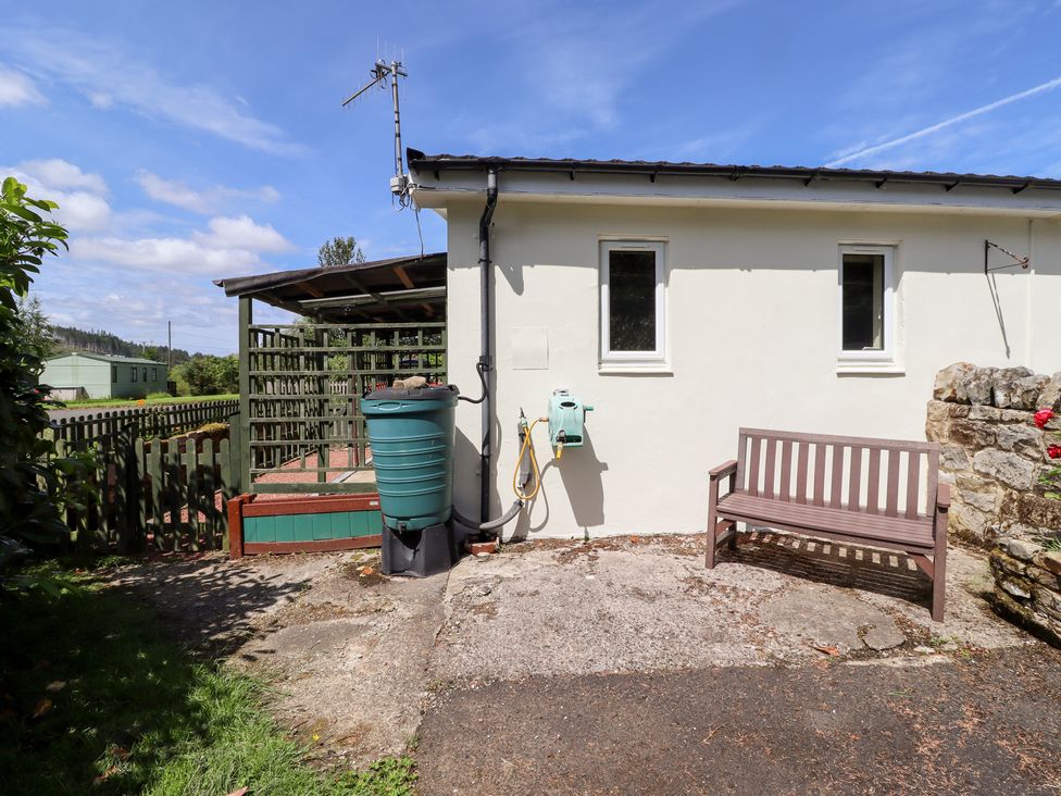 An outdoor area with a bench and equipment at Fir Tree Cottage Cottonshopeburnfoot near Otterburn