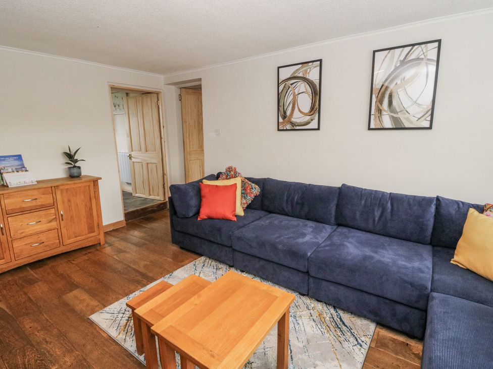 A living room with a sofa and coffee table at Daisy Cottage in Wigton