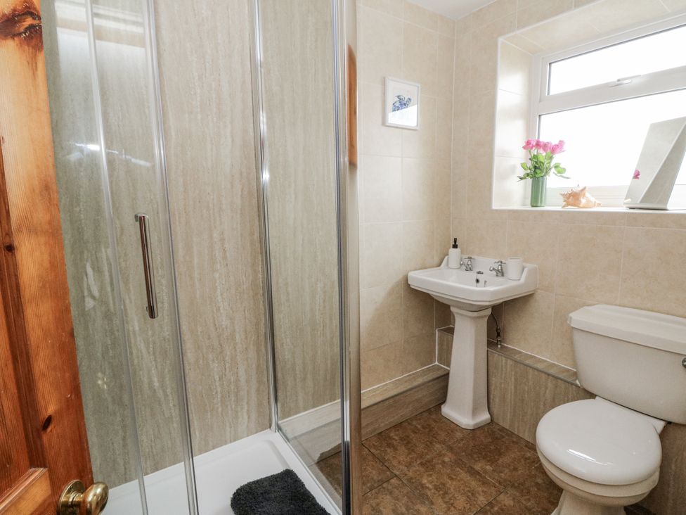 A bathroom with a shower and sink at Daisy Cottage in Wigton