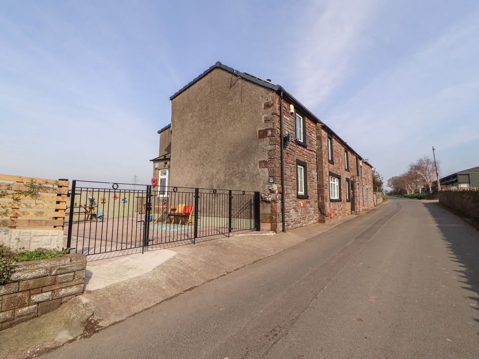 A house with a fence and garden area at Daisy Cottage Near Wigton