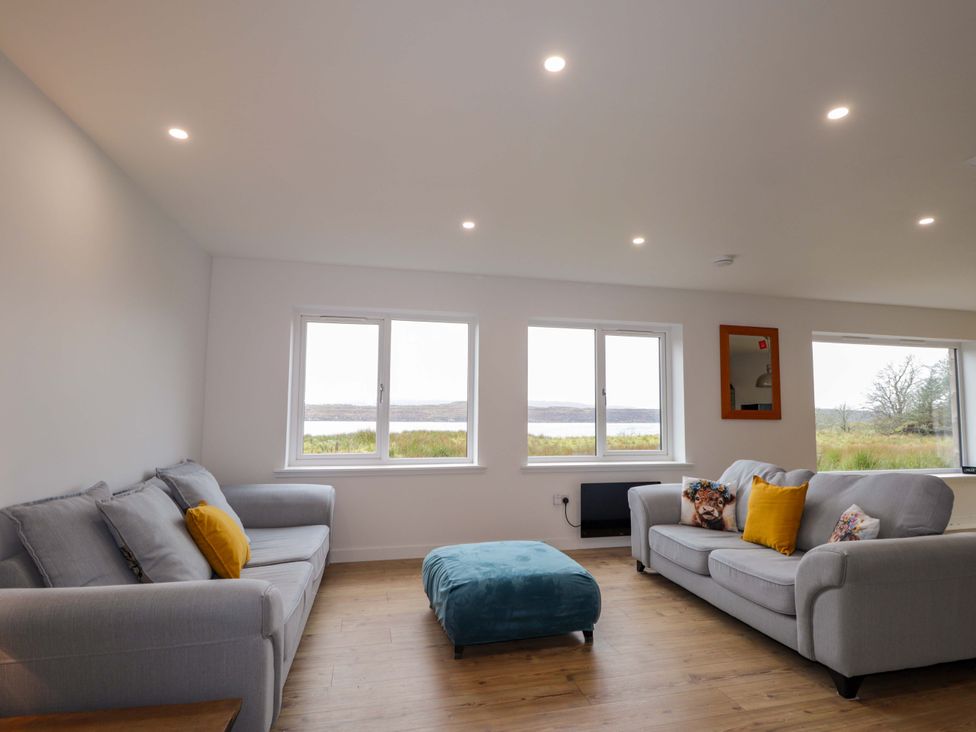 A living room with sofas and an ottoman at Faodail House in Portree