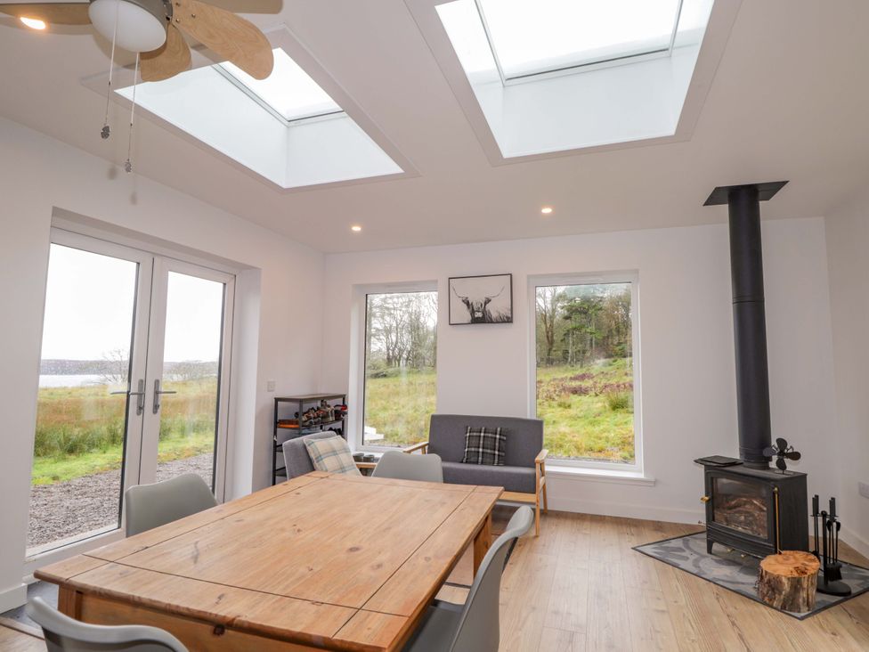 A dining room with a table and chairs at Faodail House, Portree
