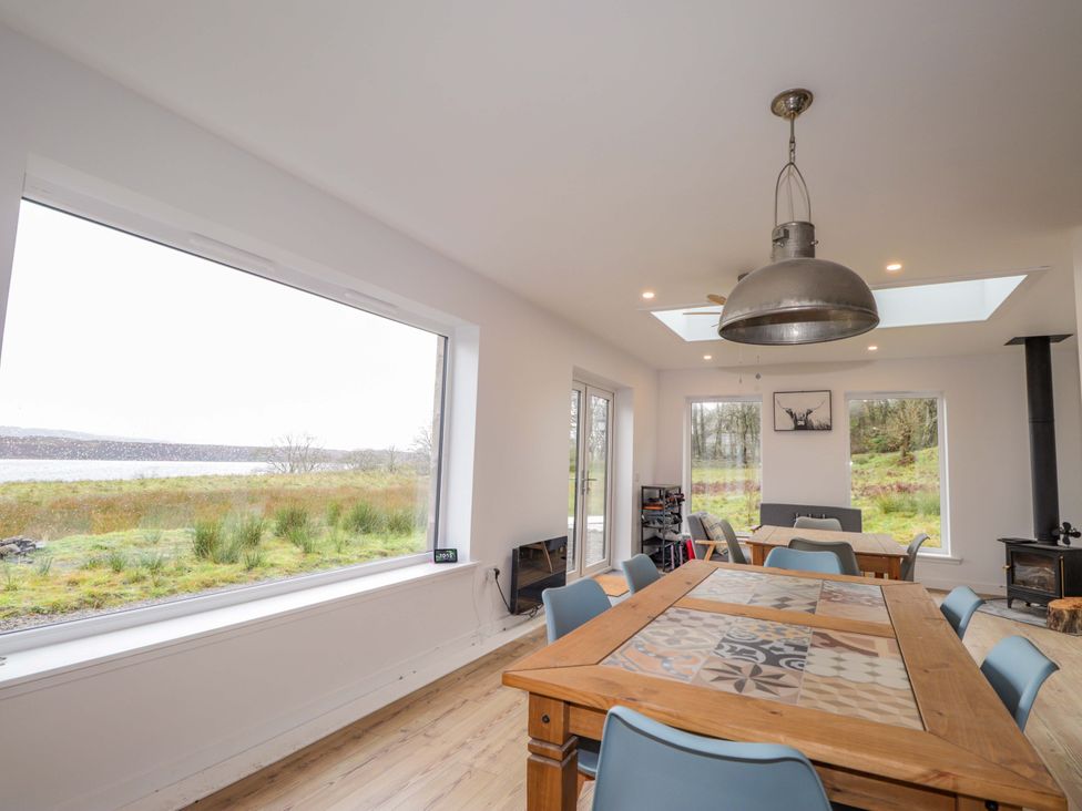 A dining room with a wooden table and chairs at Faodail House Portree