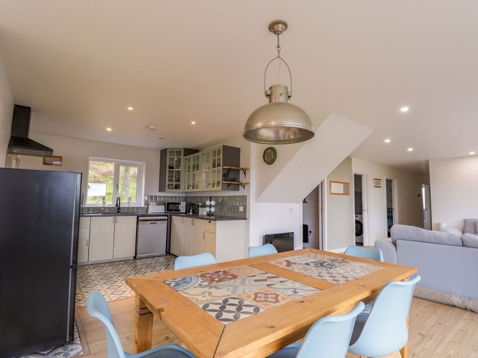 A kitchen with a table and chairs at Faodail House in Portree