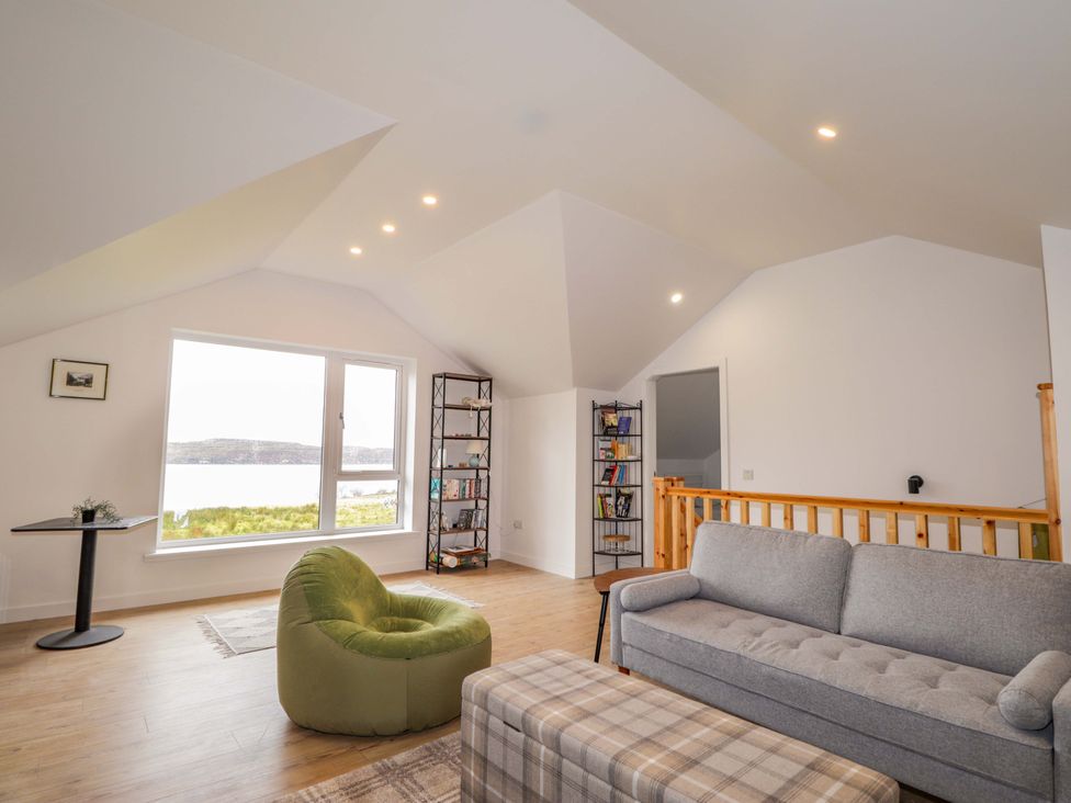 A living room with a view and furniture at Faodail House in Portree