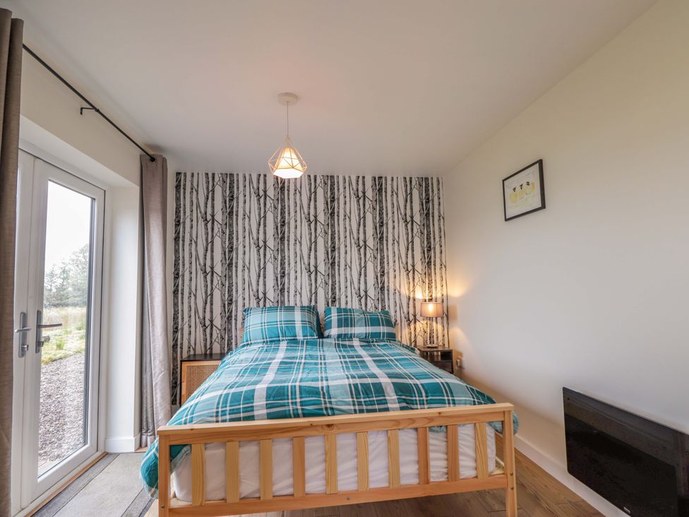 A bedroom with a bed and window at Faodail House Portree