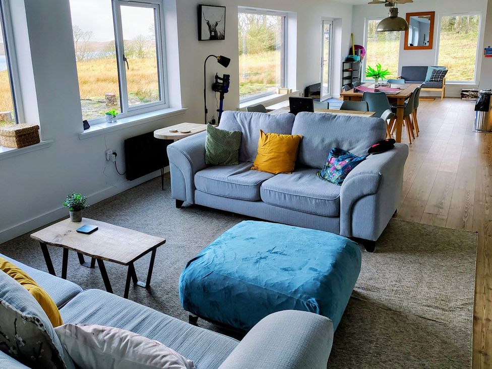 A living room with a sofa and coffee table at Faodail House Kingsburgh near Uig