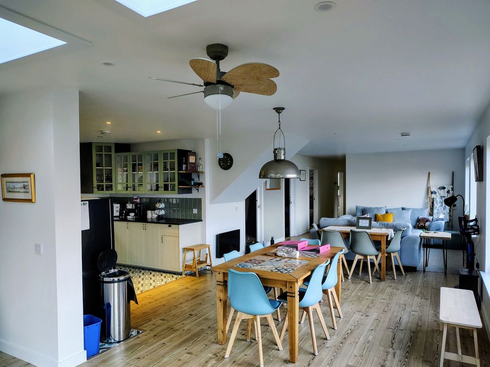 A kitchen with a dining table and chairs at Faodail House Kingsburgh near Uig