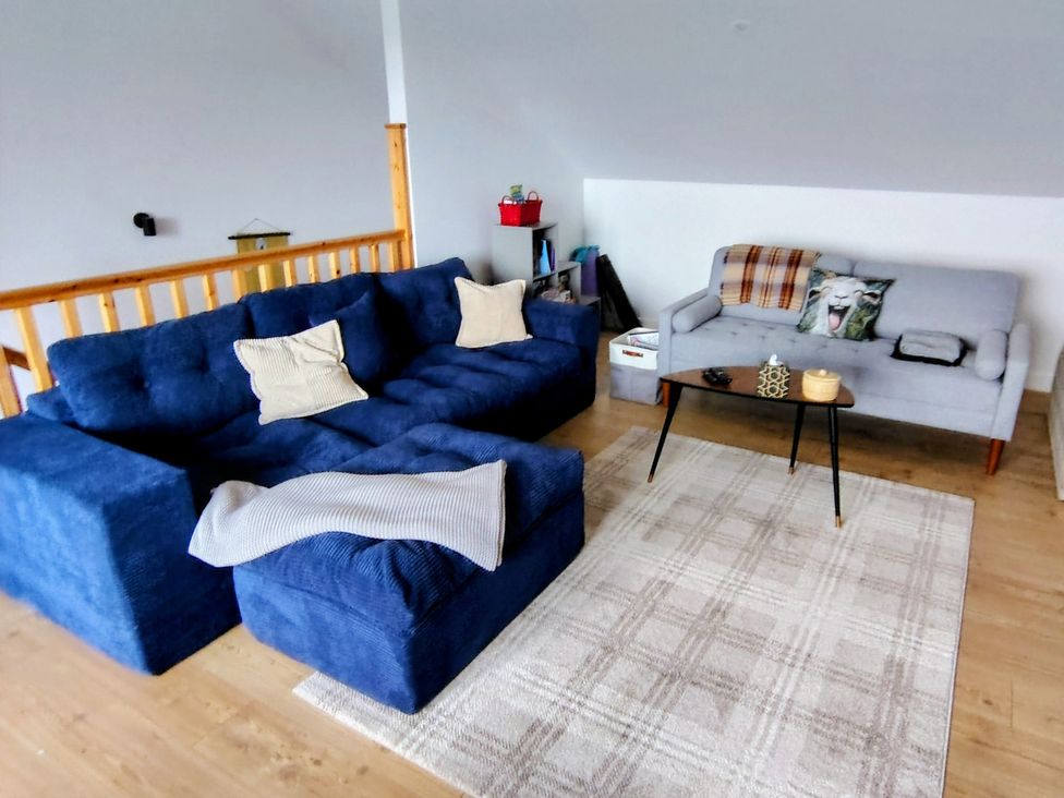 A living room with sofas and a coffee table at Faodail House in Kingsburgh near Uig