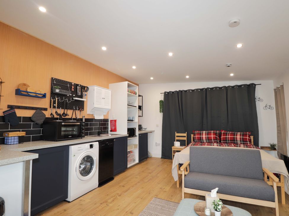 A kitchen and living room with appliances and furniture at Faodail Studio 