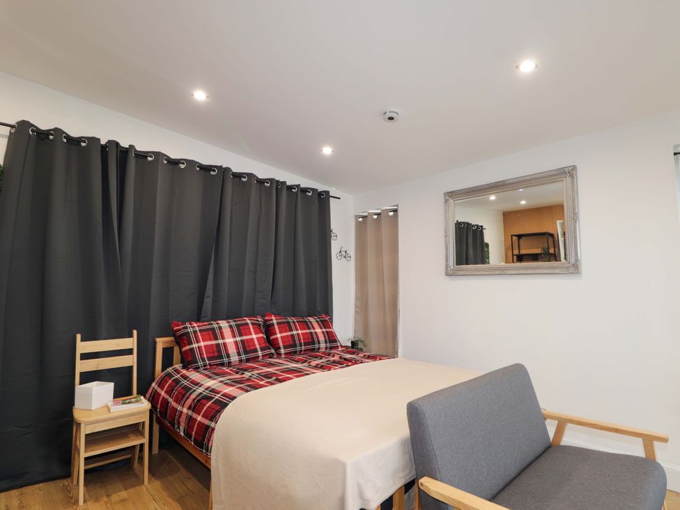 A bedroom with a bed and bedside table at Faodail Studio