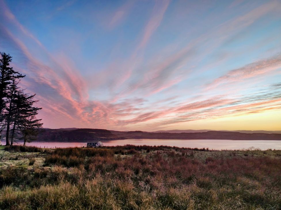 A landscape with trees, a house, and water at Faodail Studio in Kingsburgh near Uig