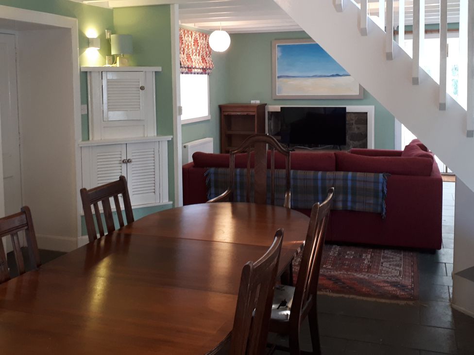 A dining room with a table and chairs at Taigh Phinc, Balemore near Lochmaddy, North Uist