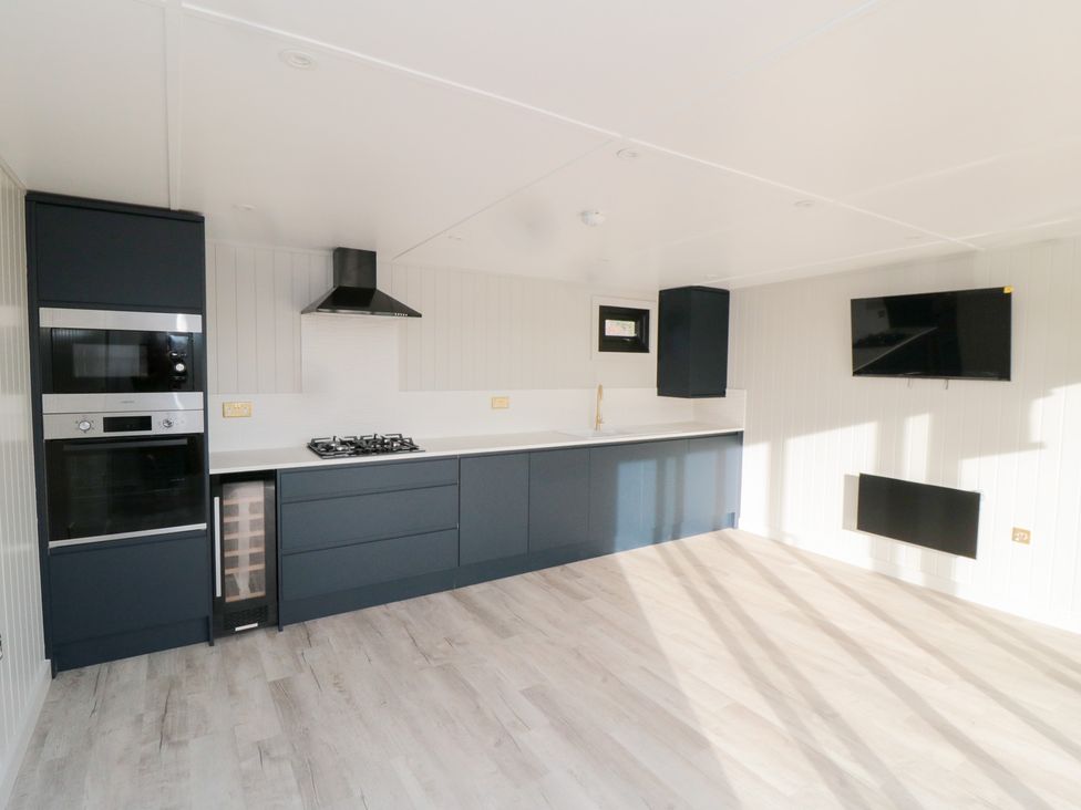 A kitchen with appliances and a television at Lodge 6 Stockton-on-Tees