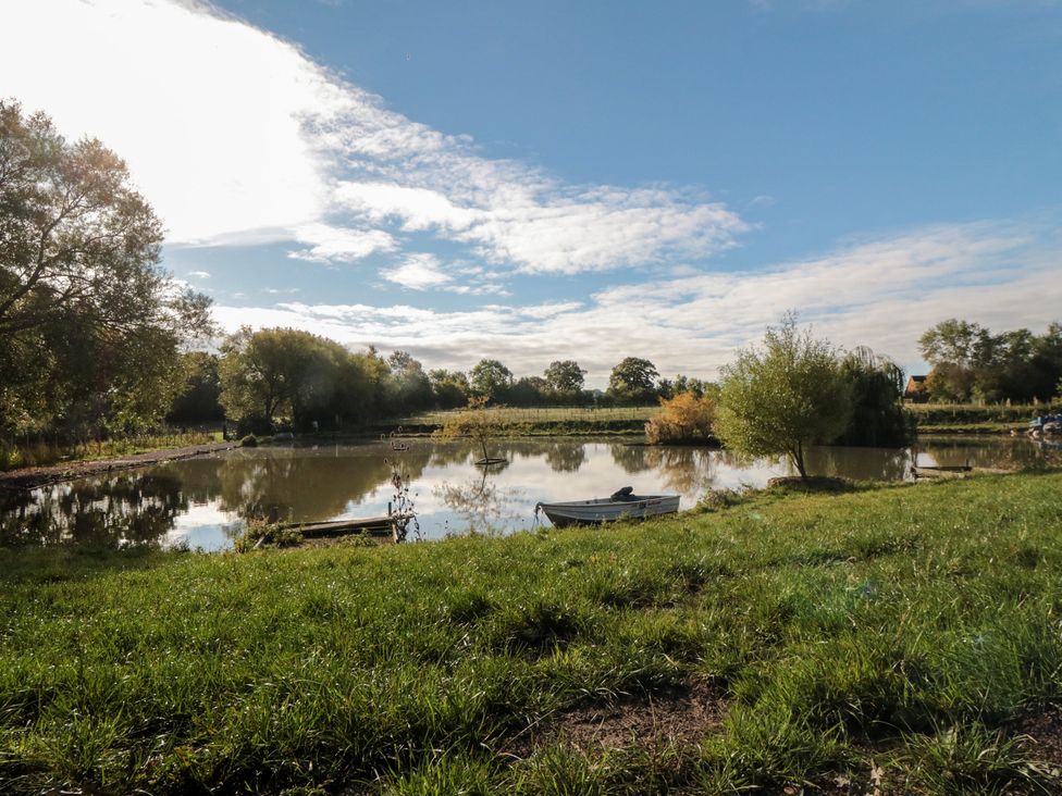 A serene landscape with boats on water near grass and trees at Lodge 7 Stockton-on-Tees