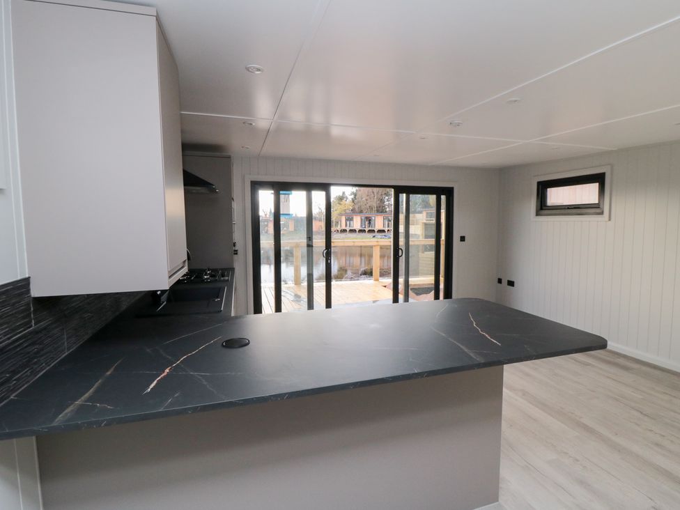 A kitchen with a countertop and sliding doors at Lodge 7 in Stockton-on-Tees