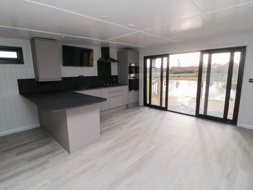 A kitchen with an island and sliding doors at Lodge 8 in Stockton-on-Tees