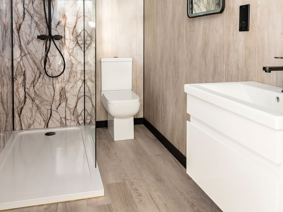 A bathroom with a shower, toilet, and sink at Mandarin Lodge Yarm