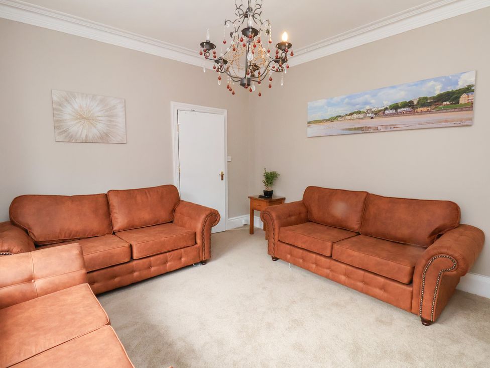 A living room with two sofas and a table at Rutland Grange in Filey