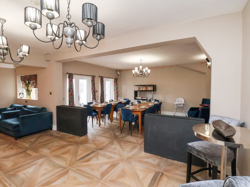 A dining room with a table and chairs at Rutland Grange in Filey