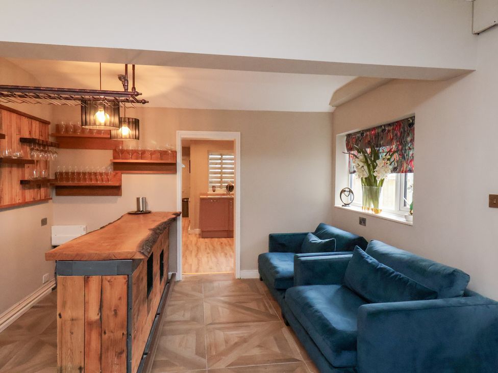 A snug area with a bar and seating at Rutland Grange in Filey