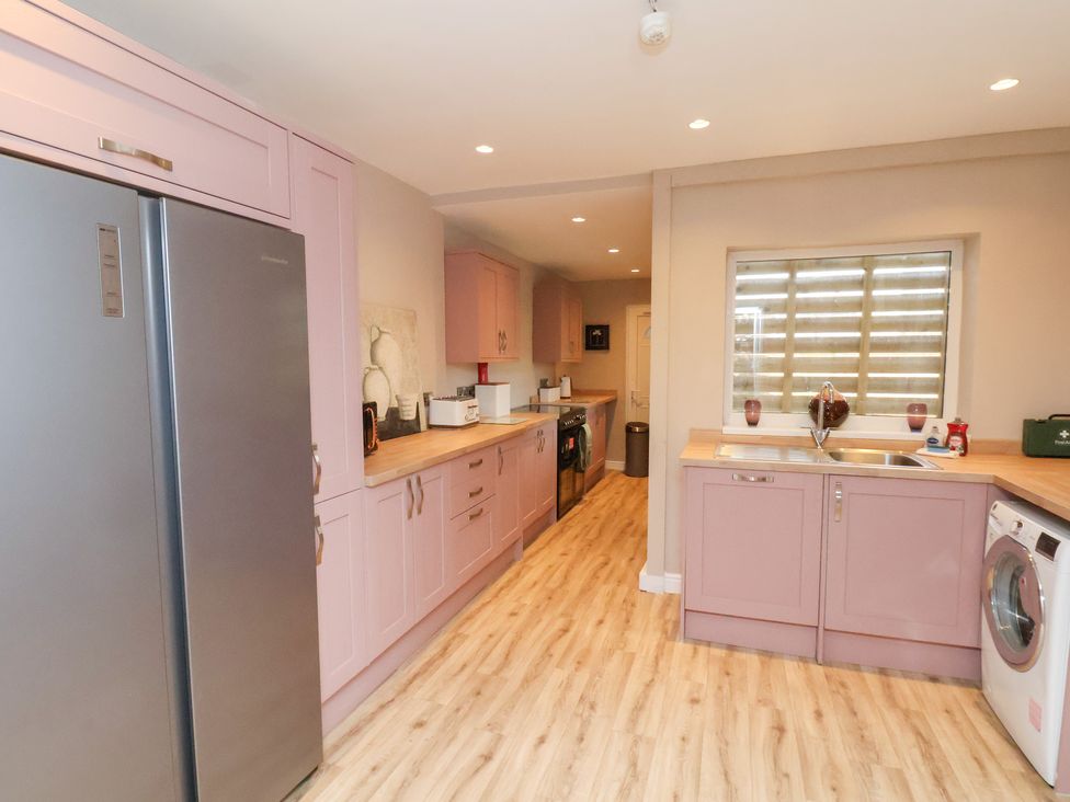 A kitchen with cabinets and appliances at Rutland Grange in Filey