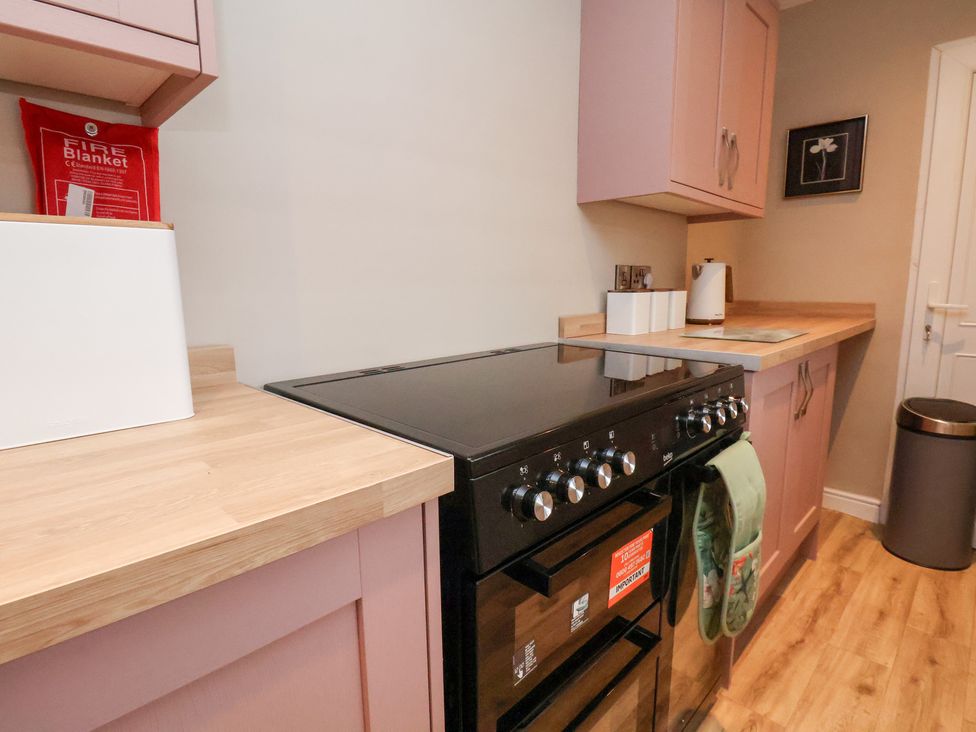 A kitchen with a cooker and countertop at Rutland Grange in Filey