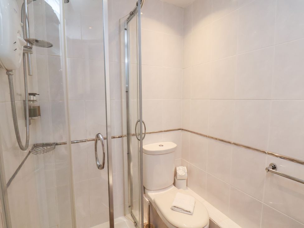 A bathroom with a shower and toilet at Rutland Grange in Filey