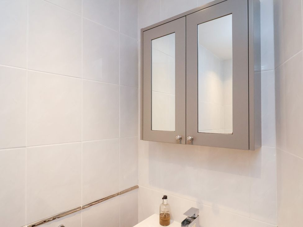 A bathroom with a mirror cabinet and sink at Rutland Grange in Filey