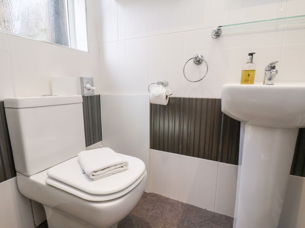 A bathroom with a toilet and sink at Rutland Grange in Filey