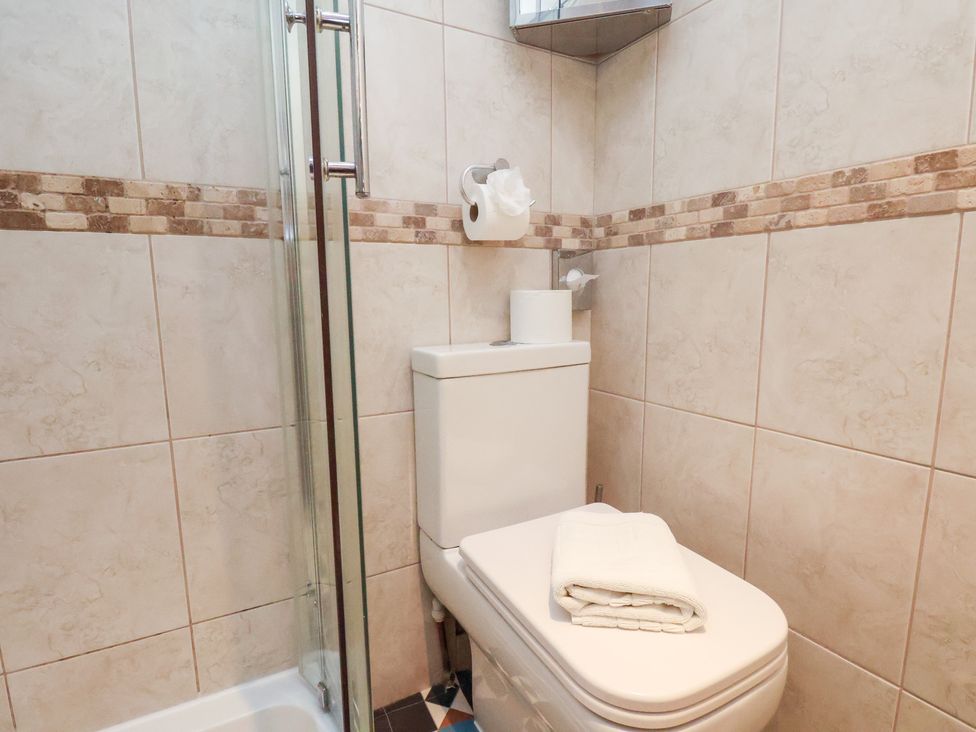 A bathroom featuring a toilet and shower at Rutland Grange in Filey