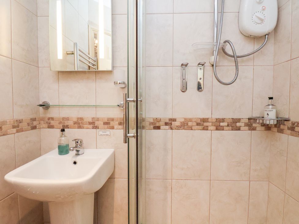 A bathroom featuring a sink and shower at Rutland Grange in Filey
