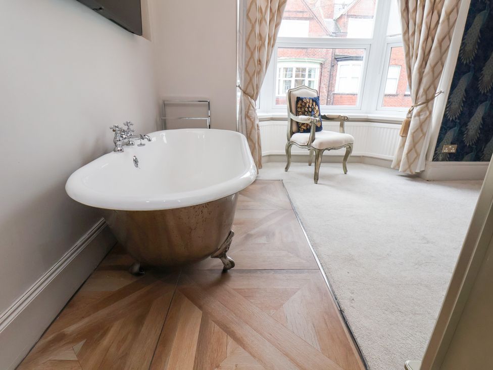 A bathtub in a bathroom at Rutland Grange in Filey