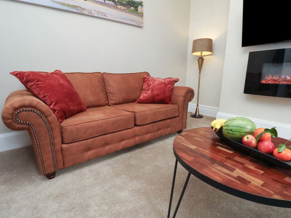 A living room with a sofa and coffee table at Rutland Grange in Filey