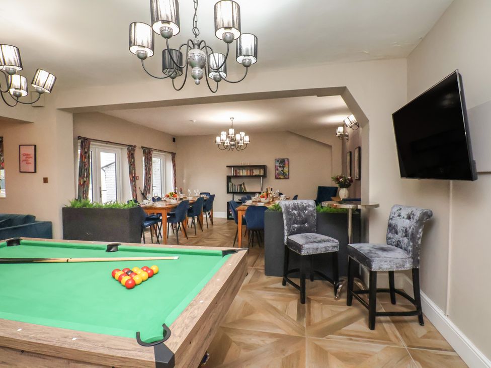 A game room with a pool table and dining area at Rutland Grange in Filey