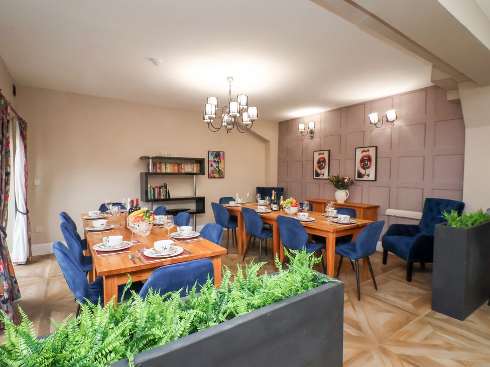 A dining room with tables and chairs at Rutland Grange in Filey
