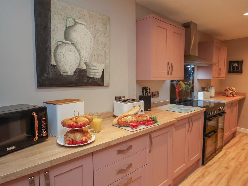 A kitchen with appliances and food on a countertop at Rutland Grange in Filey