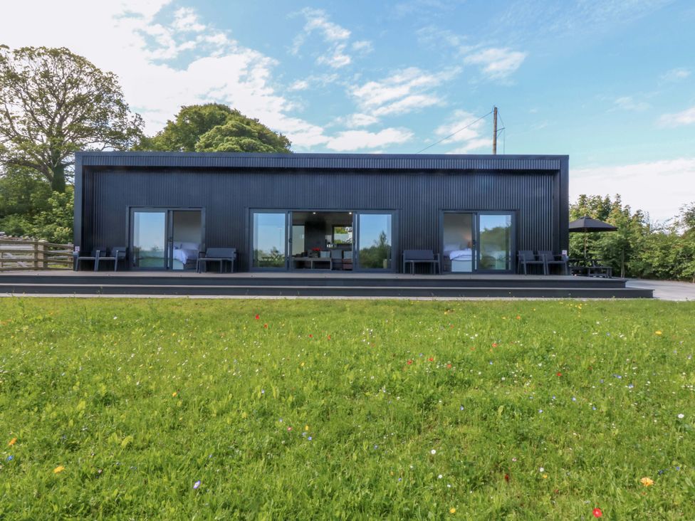 A house with large windows and a patio at Y Cwt Moelfre