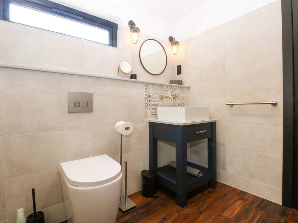 A bathroom with a sink and toilet at Y Cwt in Moelfre