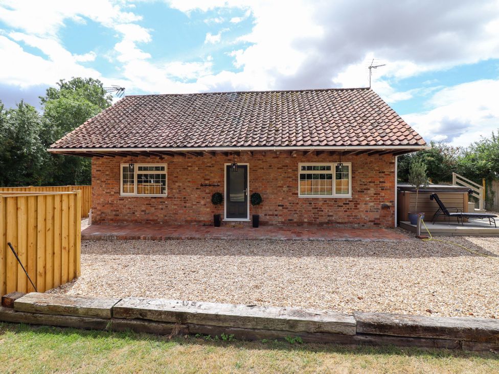 A house exterior with gravel area and garden at Wood Farm Cottage Stickney near East Kirkby