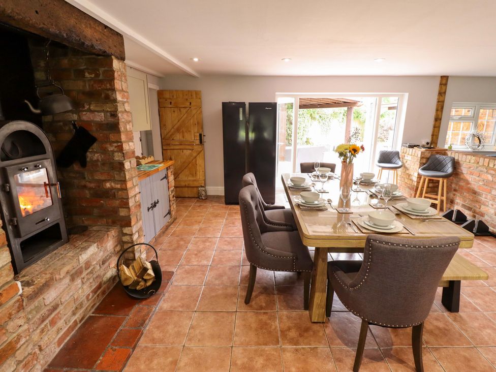 A kitchen with dining table and chairs at Wood Farm Cottage near Stickney