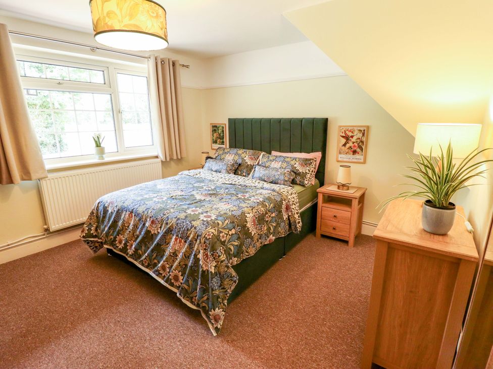 A bedroom with a bed and nightstand at Wood Farm Cottage Stickney near East Kirkby