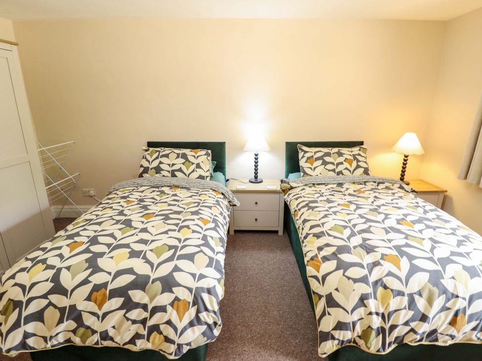 A bedroom with two beds and a lamp at Wood Farm Cottage Stickney near East Kirkby
