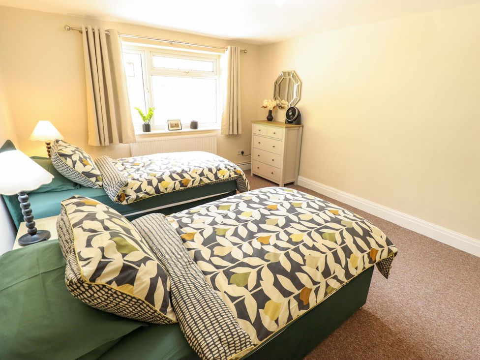 A bedroom with two beds and a dresser at Wood Farm Cottage Stickney near East Kirkby