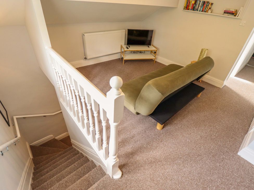 A landing with a sofa and television at Wood Farm Cottage Stickney near East Kirkby
