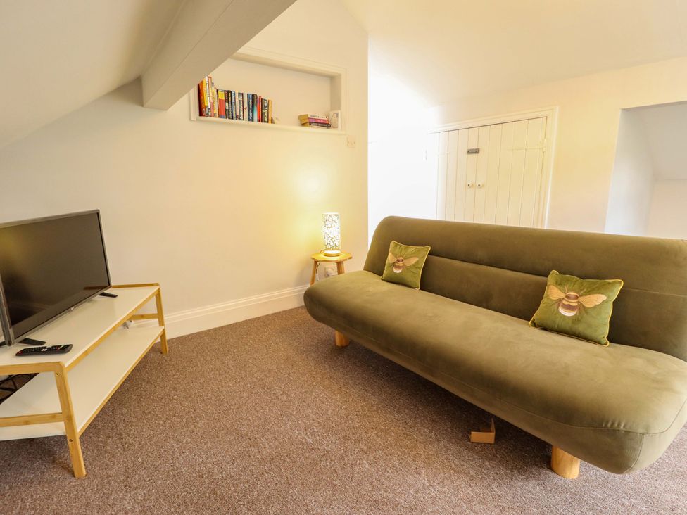 A living room with a sofa and television at Wood Farm Cottage Stickney near East Kirkby