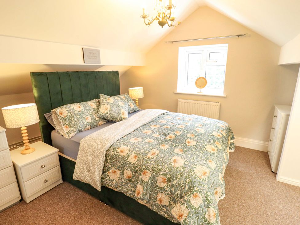 A bedroom with a bed and nightstands at Wood Farm Cottage Stickney near East Kirkby