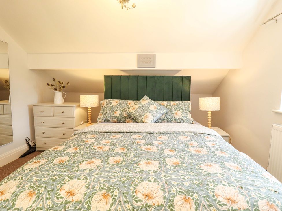 A bedroom with a bed and bedside table at Wood Farm Cottage Stickney near East Kirkby